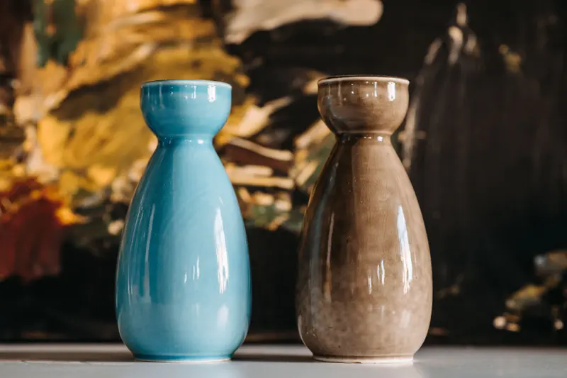 Two glazed vases in blue and brown, colours like those in AMACO glaze combinations.