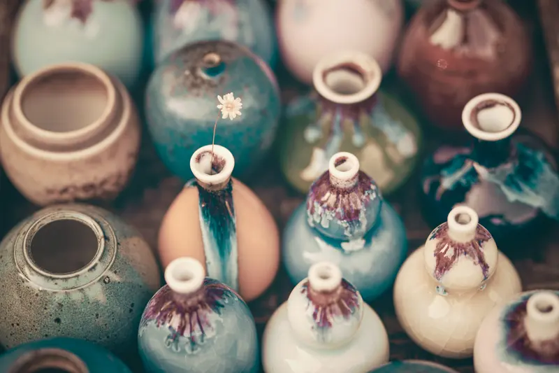 Colourful handmade ceramic vases in different glazes, the range a glaze chart helps you plan.