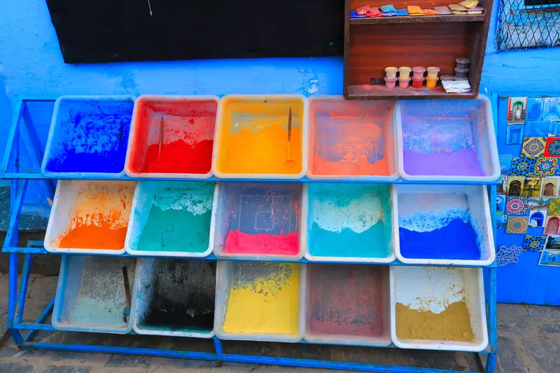 Trays of coloured powdered pigments, similar in look to the powders listed on a Mason stain chart.