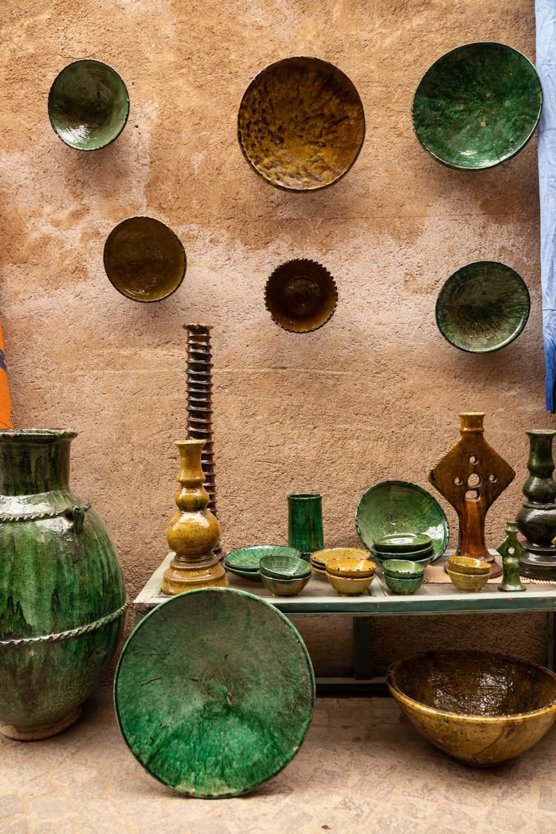 Wall of pottery glaze jars in a ceramic studio