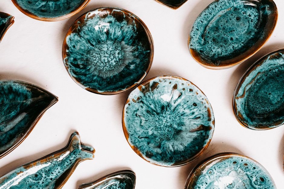 Rows of ceramic glaze bottles on a studio shelf
