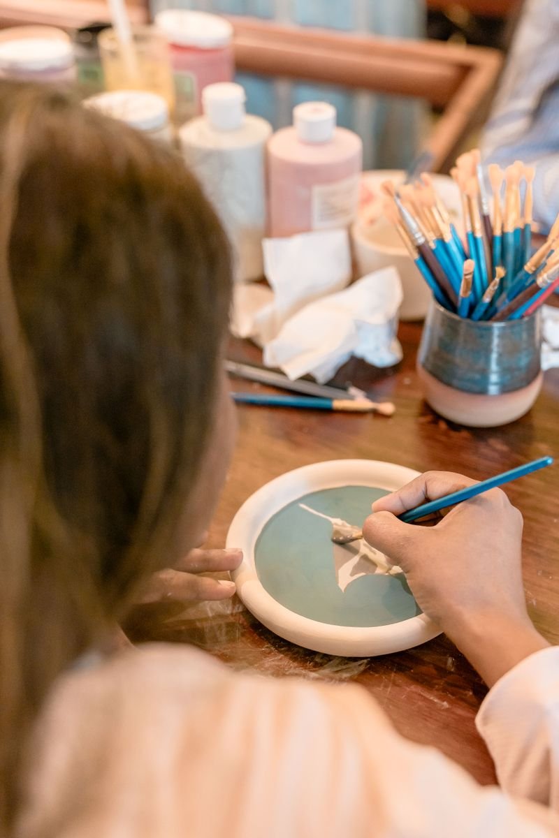 Brushing pottery ceramic glaze onto a bowl