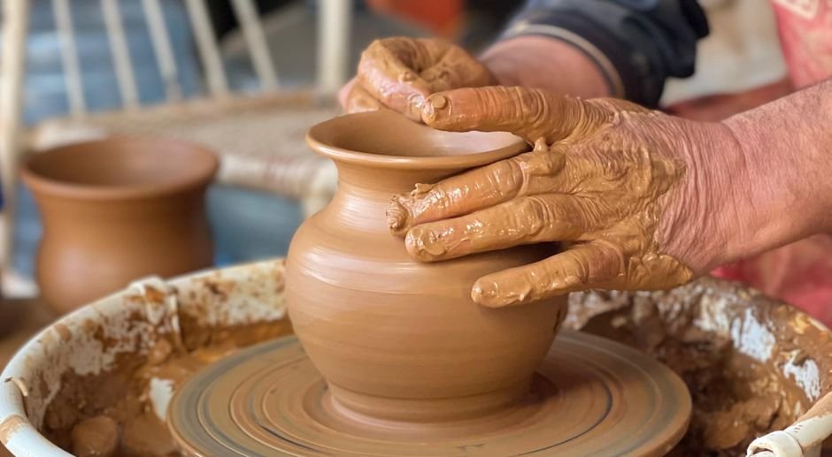 Two pottery wheels set up side by side in a studio