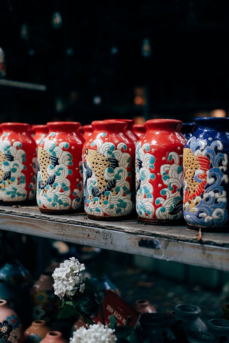 Colorful underglaze painted pottery pieces on a shelf