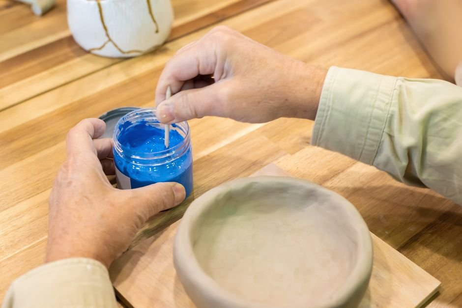 Potter mixing glaze materials sourced from a ceramics supplier