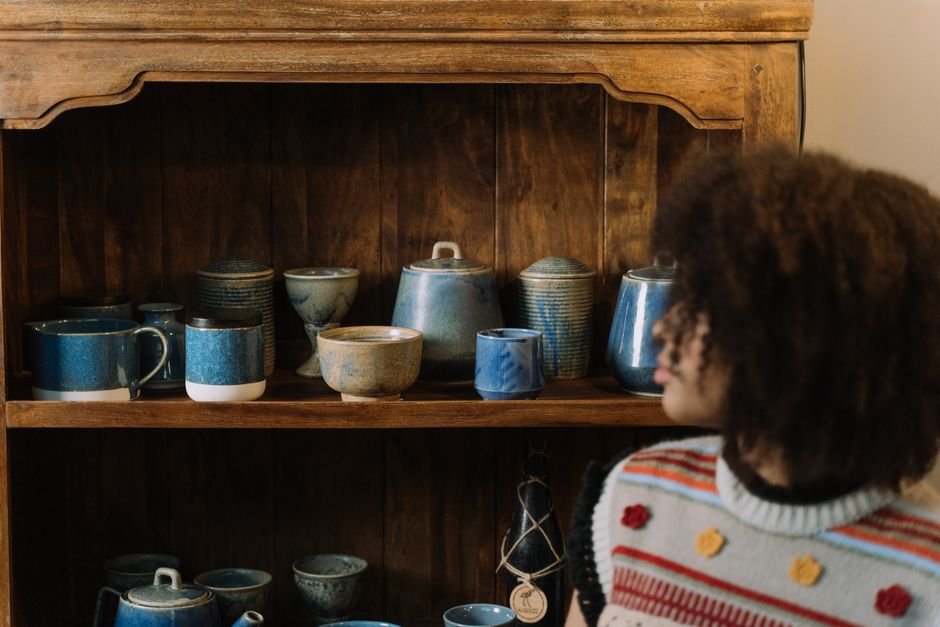 Potter comparing two glazed ceramic mugs with different finishes