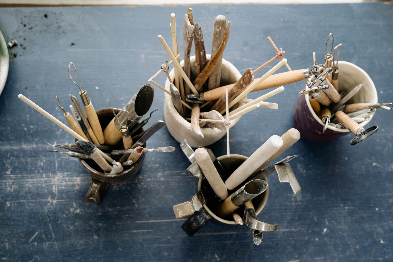 Pottery trimming tools laid out on a studio table