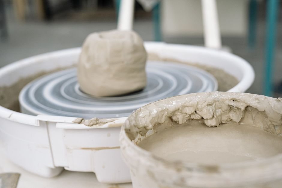 Detailed view of wet clay on a pottery wheel during throwing