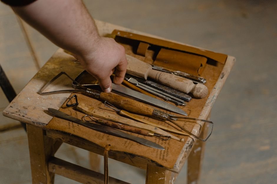 Basic pottery hand tools arranged on a wooden table