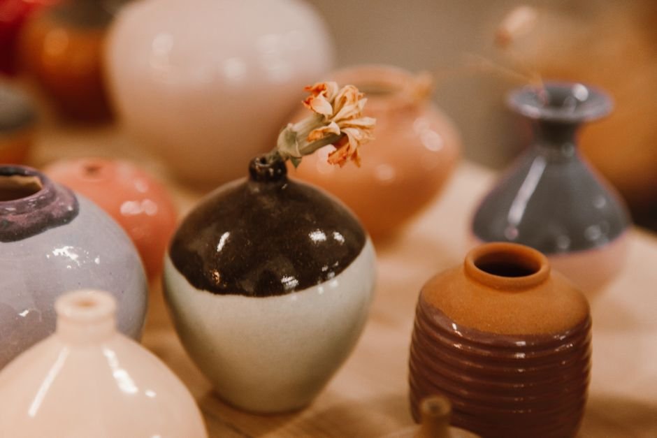 Glazed ceramic vases in various colours showing different glaze finishes and ingredient effects