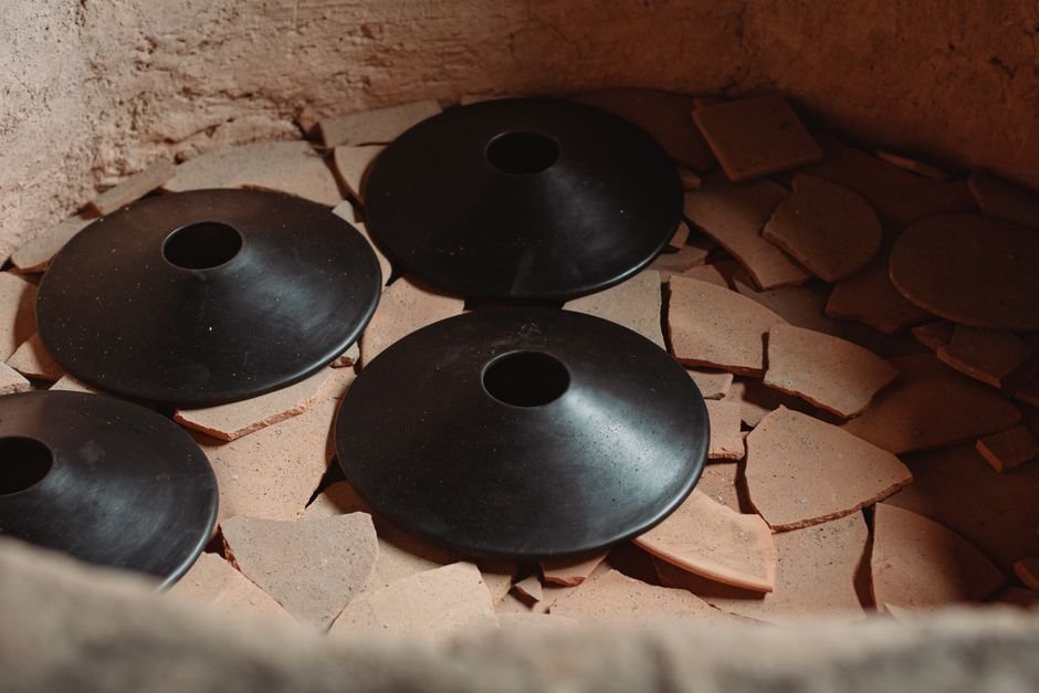 Pottery kiln with fired ceramic pieces showing a range of glaze results after firing