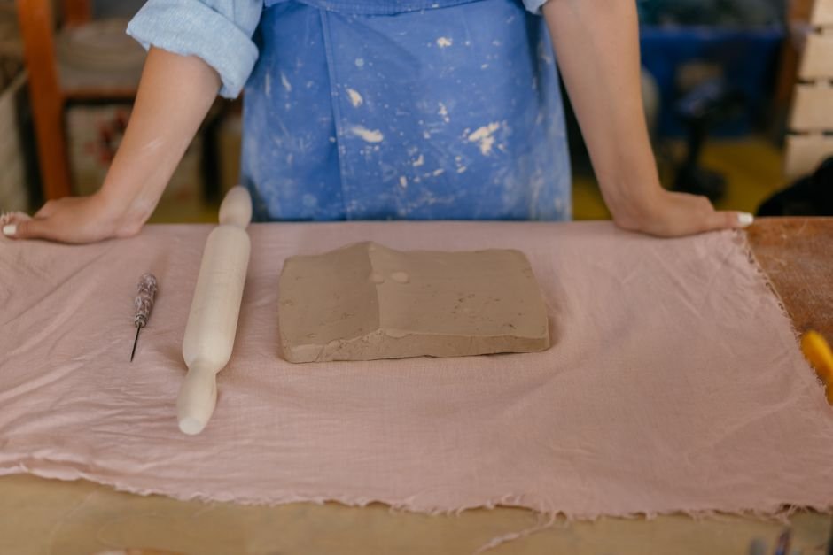 Clay slab draped over a wood hump form to shape a bowl