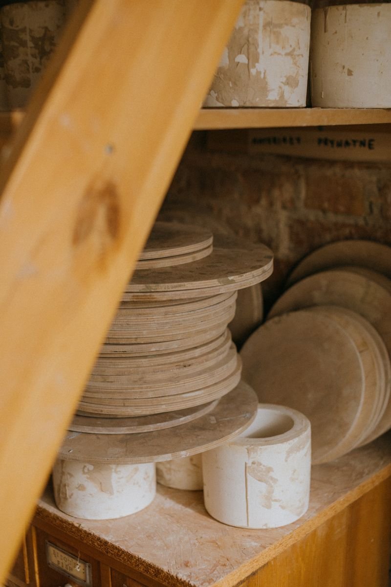 Plaster ceramic slip casting molds stacked in a pottery studio