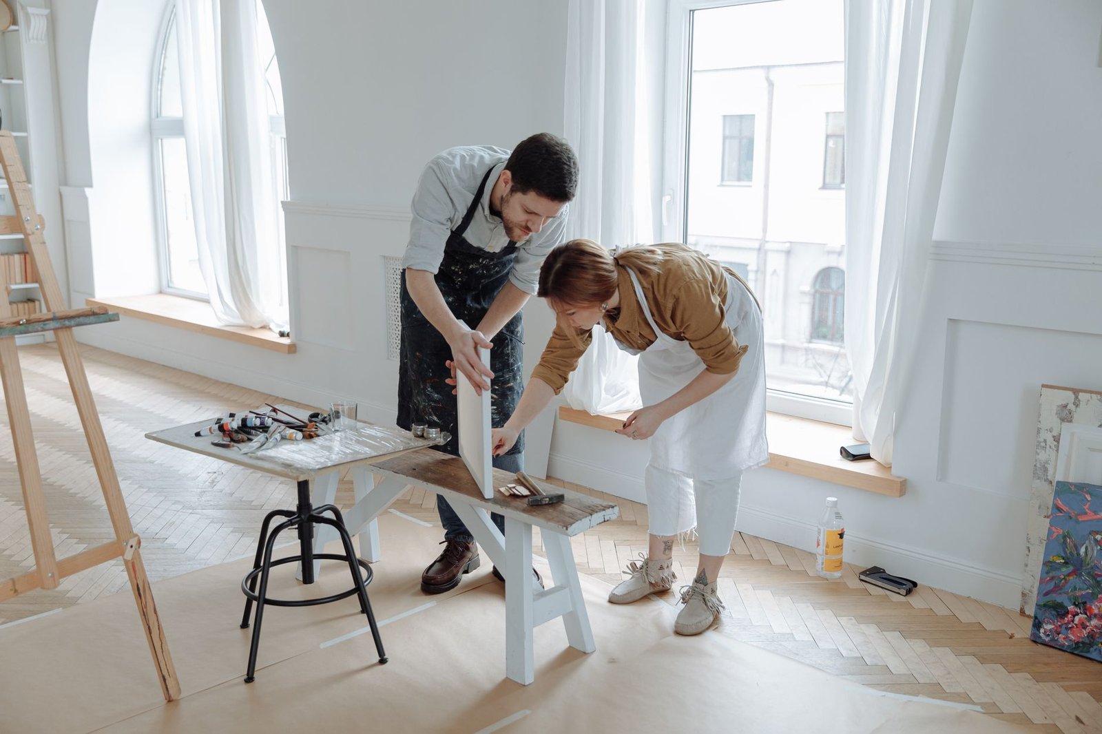 Two artists collaborating in a shared studio space