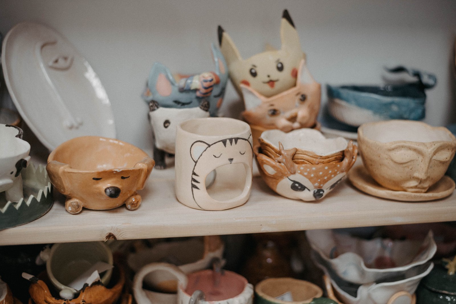 Colourful painted ceramic cups displayed on a shelf