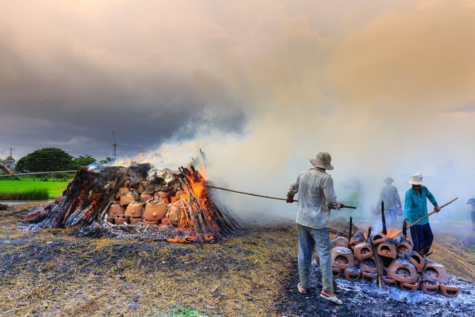 Ancient style pit firing pottery with open flame