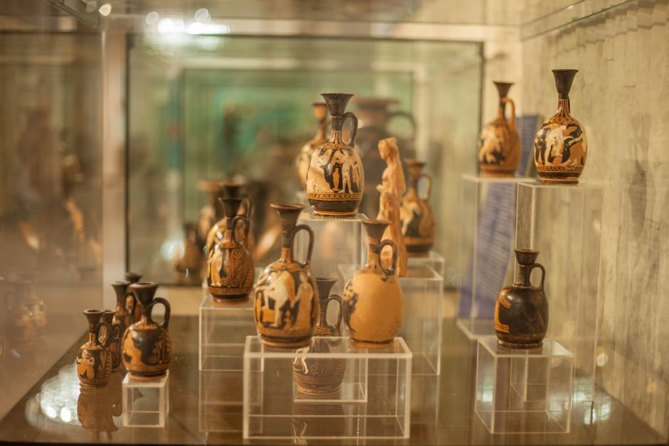 Ancient Greek pottery displayed in a museum, part of the long history of pottery
