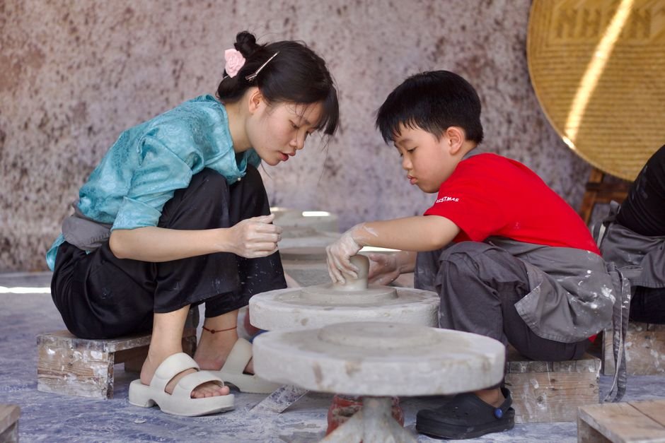 Young people in a hands-on pottery class, an alternative to buying a pottery starter kit