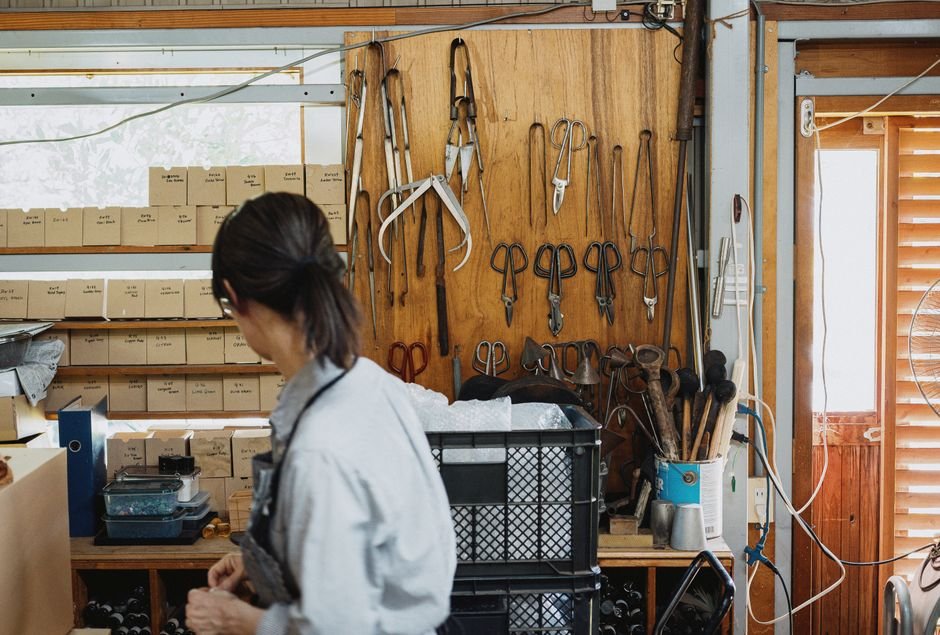Craftsman in a workshop surrounded by tools and materials, a reminder to choose clay sculpting equipment carefully
