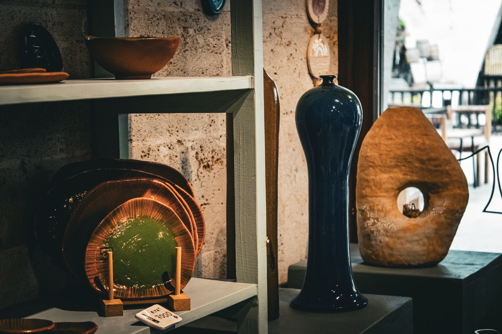 Diverse handmade ceramic pieces displayed together in a gallery