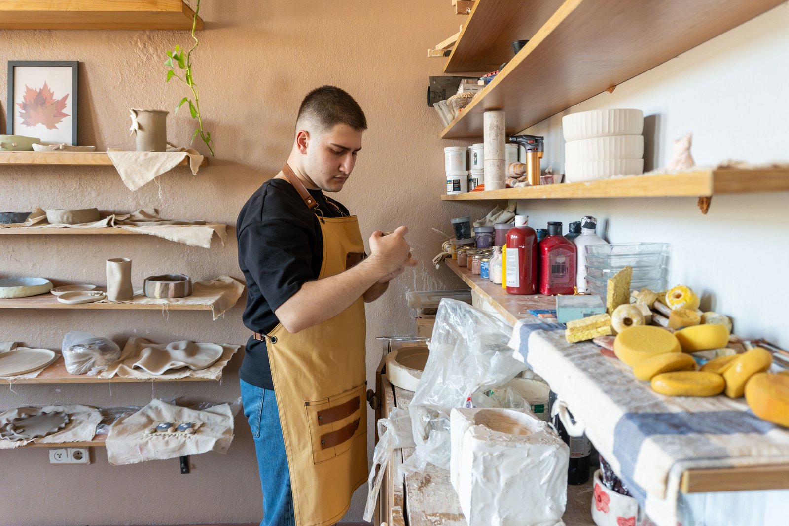 Pottery tools and supplies arranged on studio shelves