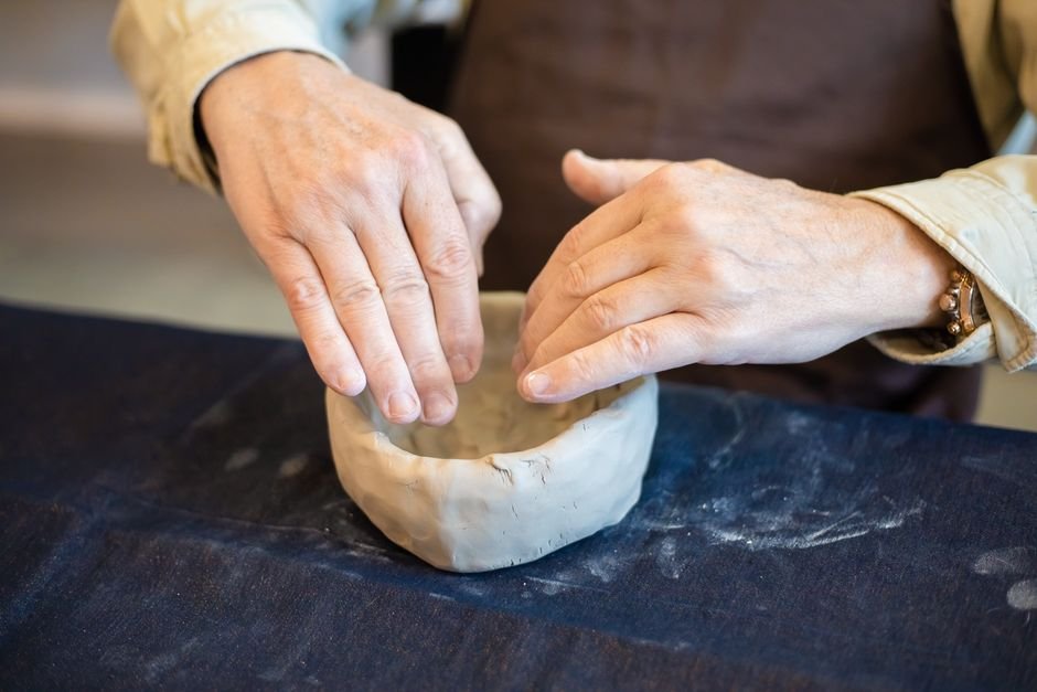 Hands molding clay into a small bowl, one of the best clay projects for a single studio session