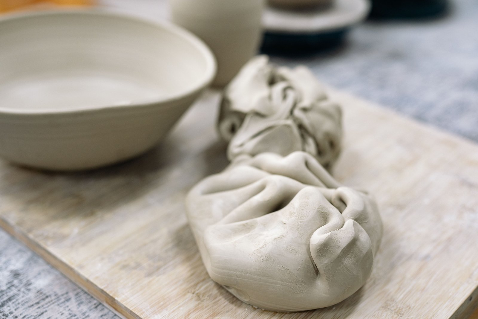 Raw clay on a wooden board ready for pottery making