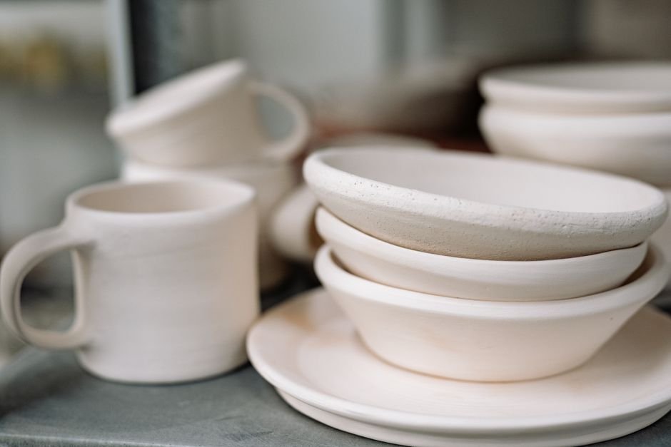Handcrafted white ceramic dinnerware set showing the clean look of porcelain pottery