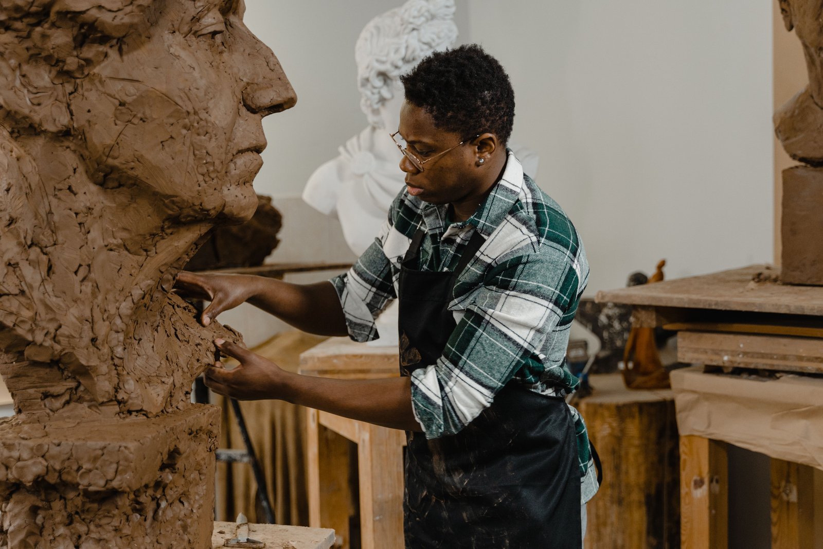 Sculptor working on a large three dimensional clay sculpture