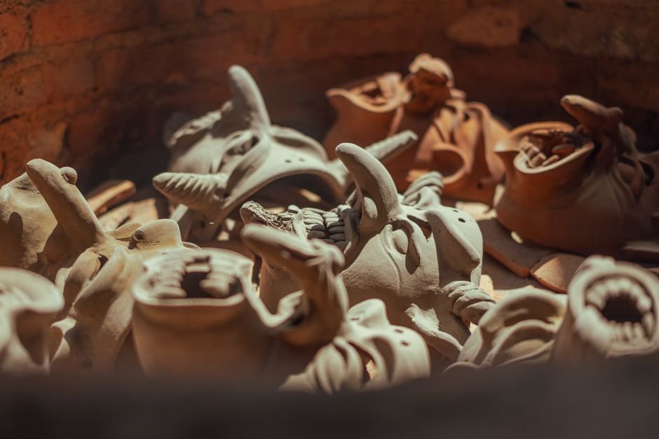 Clay masks inside a kiln, where the materials ceramic is made of are permanently transformed