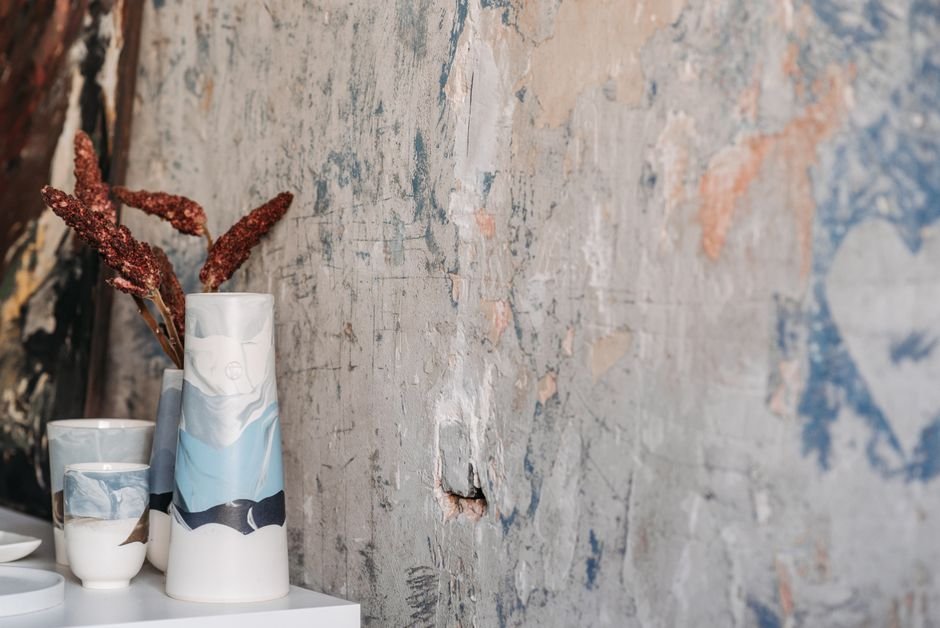 Artistic ceramic vases with dried flowers, similar to pieces offered among local sculptures for sale
