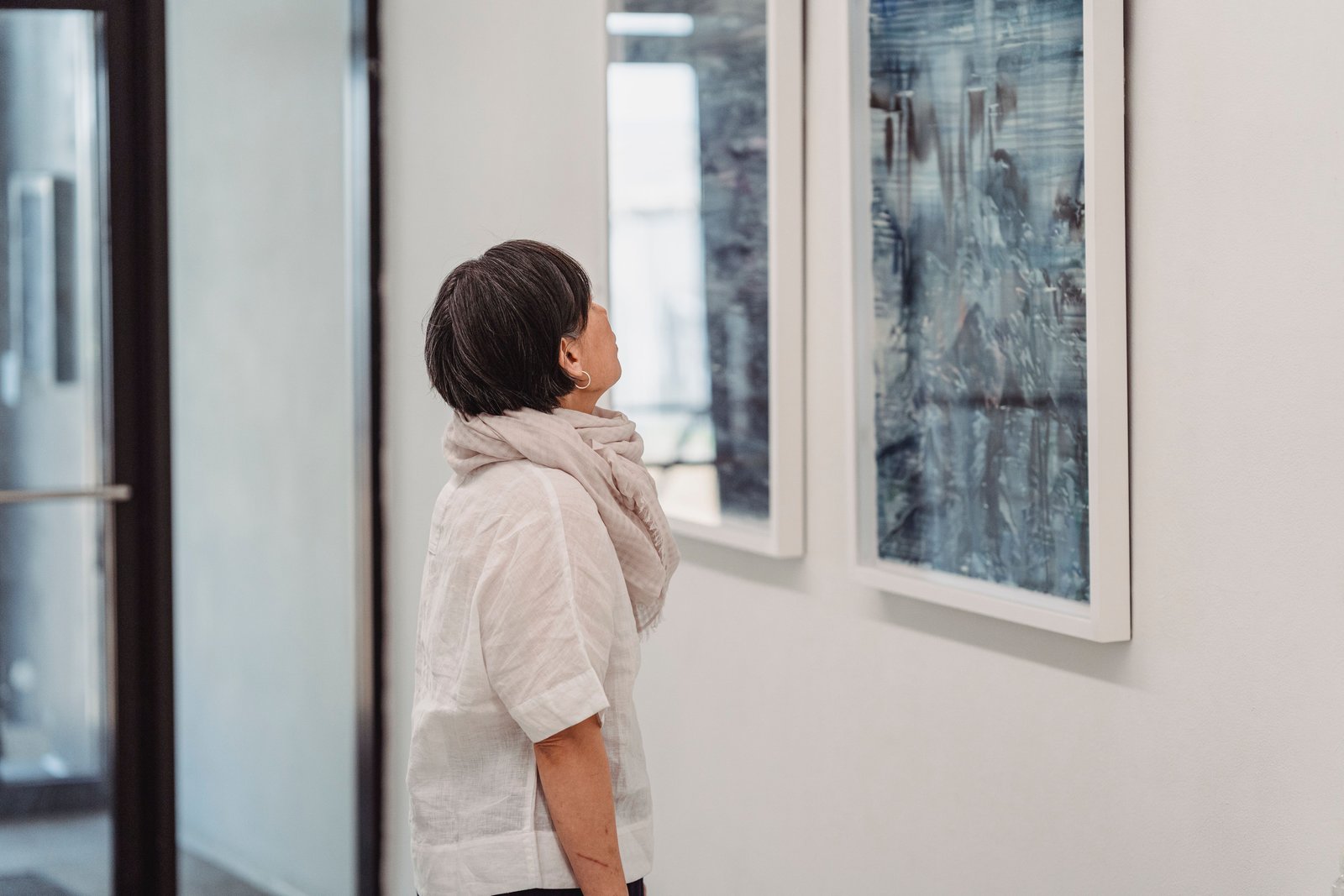 Visitor viewing artwork in a contemporary gallery exhibition