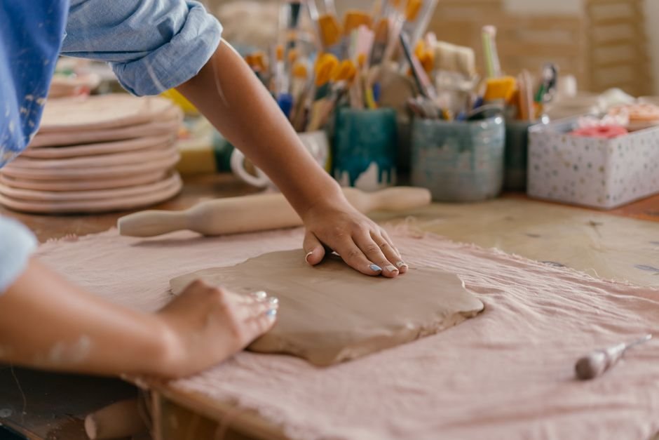 Potter hand building with grogged stoneware clay