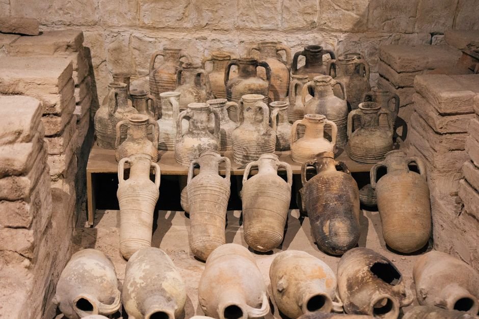 Ancient clay amphorae on museum display, showing the long story of ceramics in art history