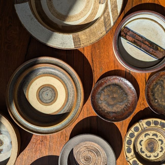 Ceramic bowls arranged on a wooden surface in natural light, a simple take on ceramics interior design trends
