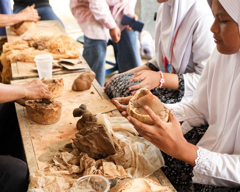Students in a hands on pottery class, where ceramic definitions are learned by doing