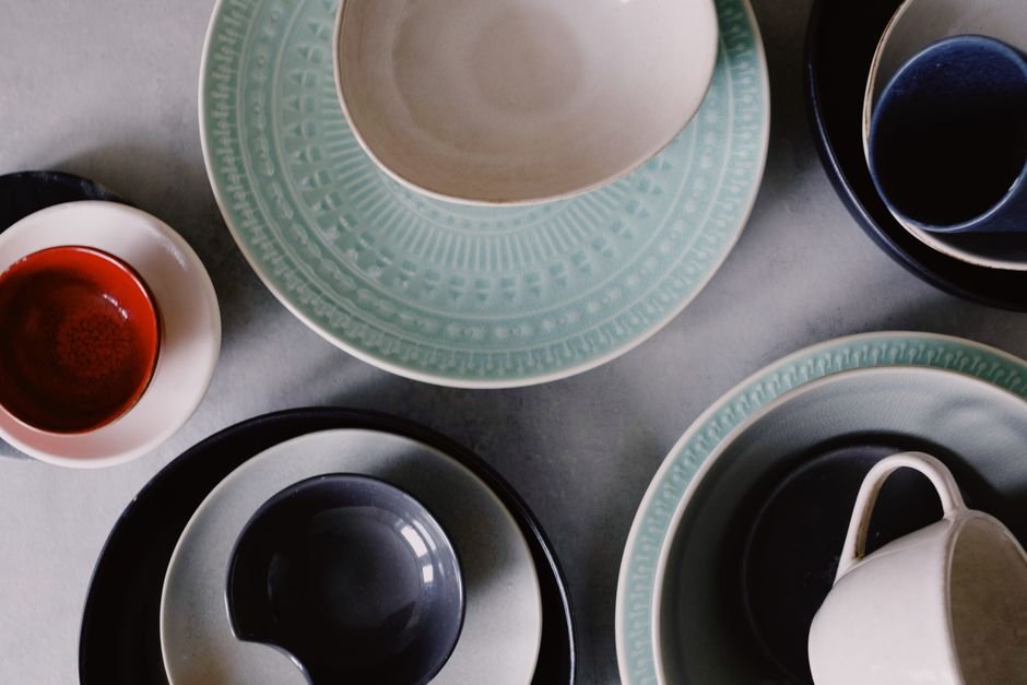 Arrangement of glazed ceramic dishware, showing the range of results from cone 6 vs cone 10 firing