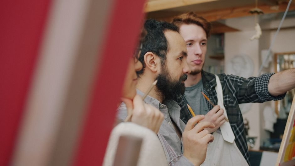 Two artists working together in a cosy studio, showing how artist studios support a local art scene