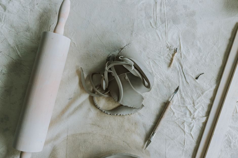 Pottery workspace with clay and hand tools, the basics of a simple pottery trimming tool kit