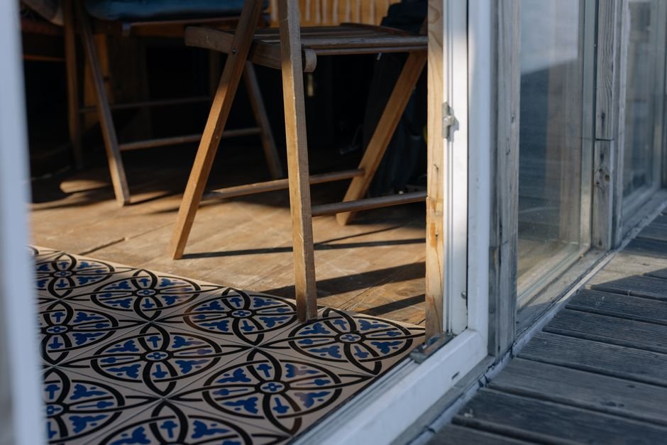 Rustic tiled floor in a sunlit room, the kind of space where unglazed ceramic tile is often chosen