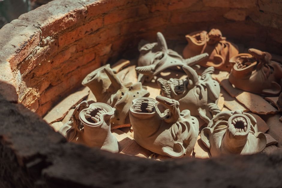 Clay pieces inside a kiln chamber, showing the space top loading vs front loading kilns are built around