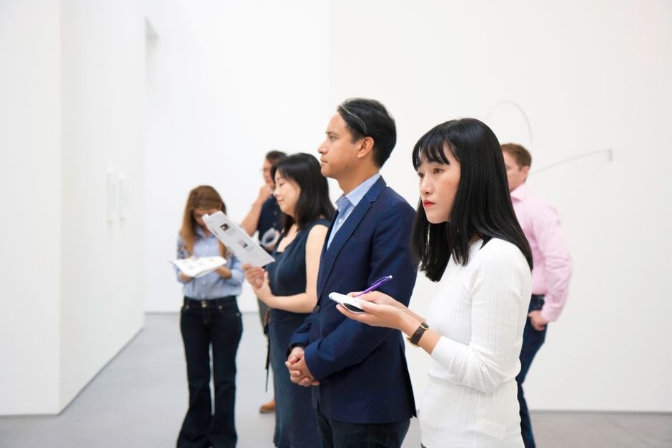 Visitors viewing work in a modern gallery, the public side of artist studios in a local art scene