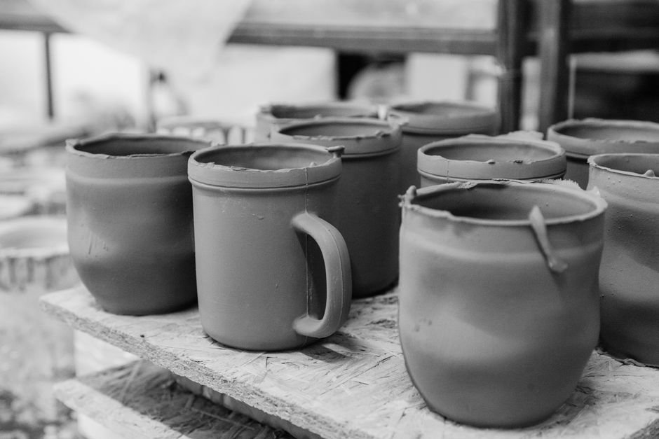 Handmade ceramic mugs in a pottery workshop, one of the most useful wheel pottery ideas