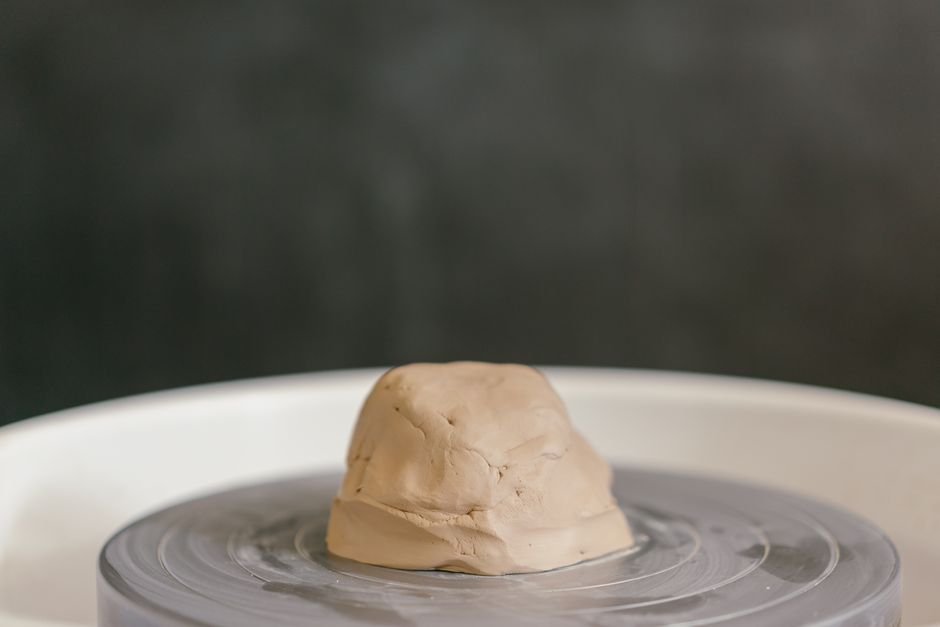 Close up of clay spinning on a pottery wheel, showing the feel of clay for pottery wheel throwing